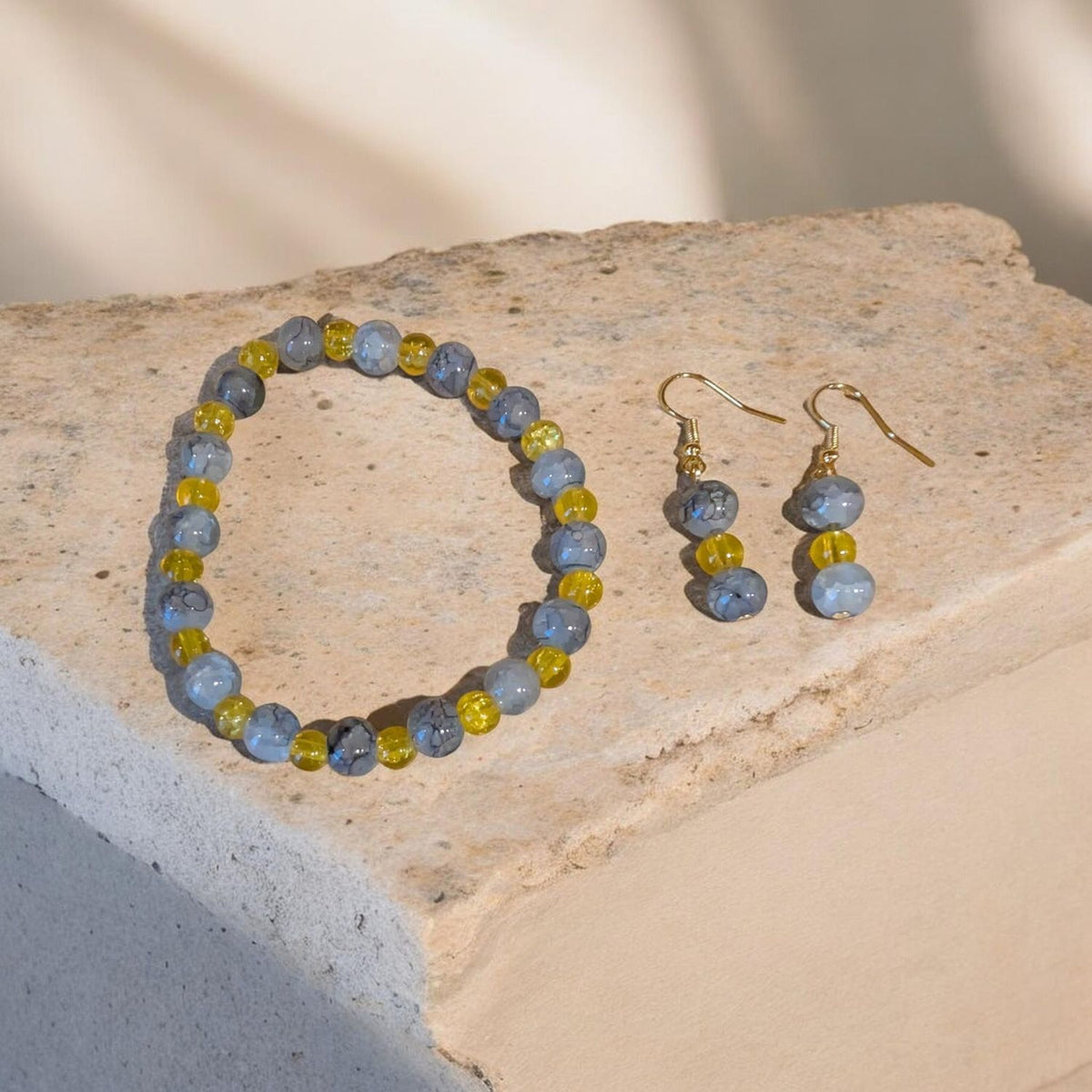 Blue marbled‑bead bracelet and matching earrings with yellow accents